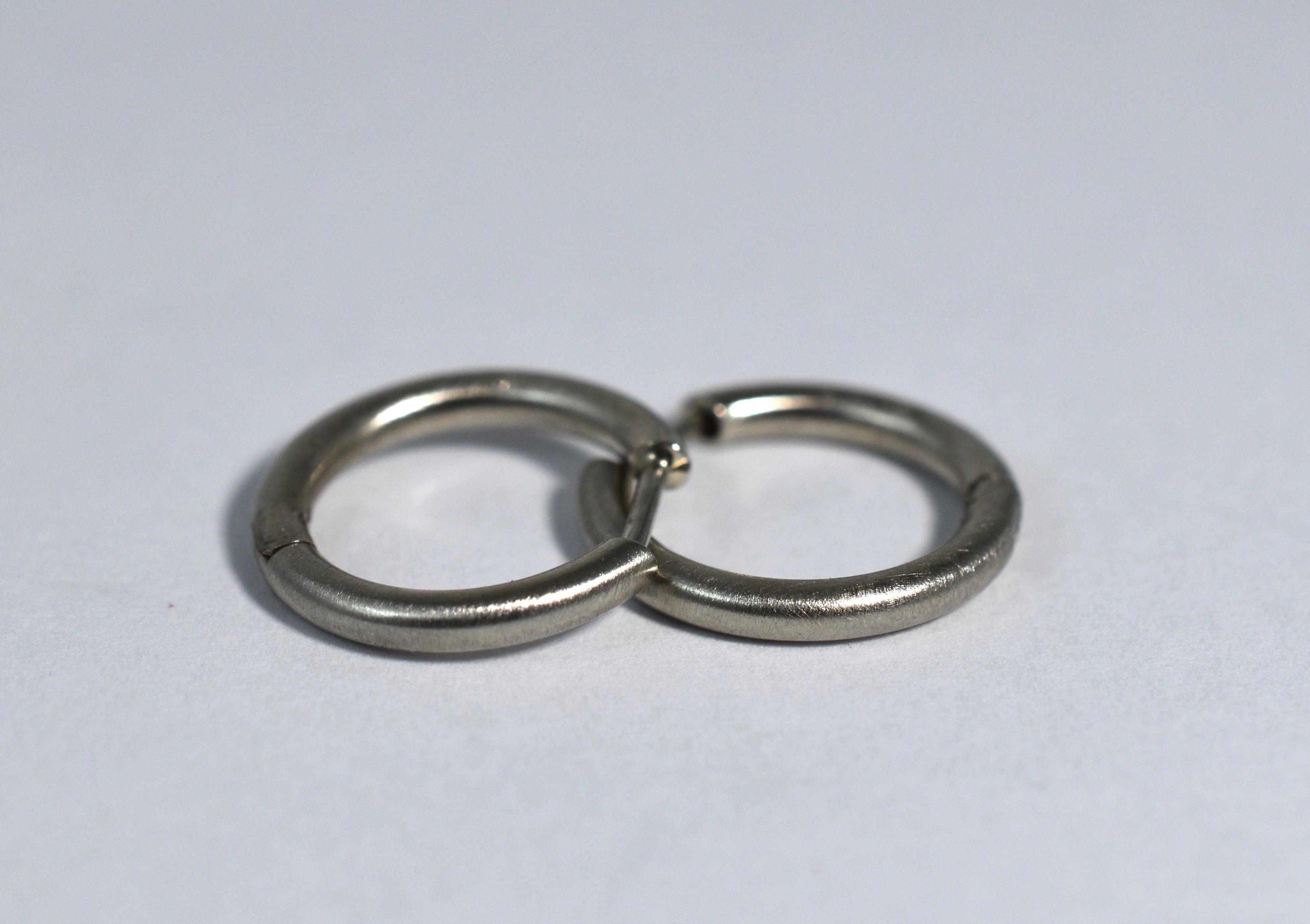 19 karat white brushed gold small locking hoops