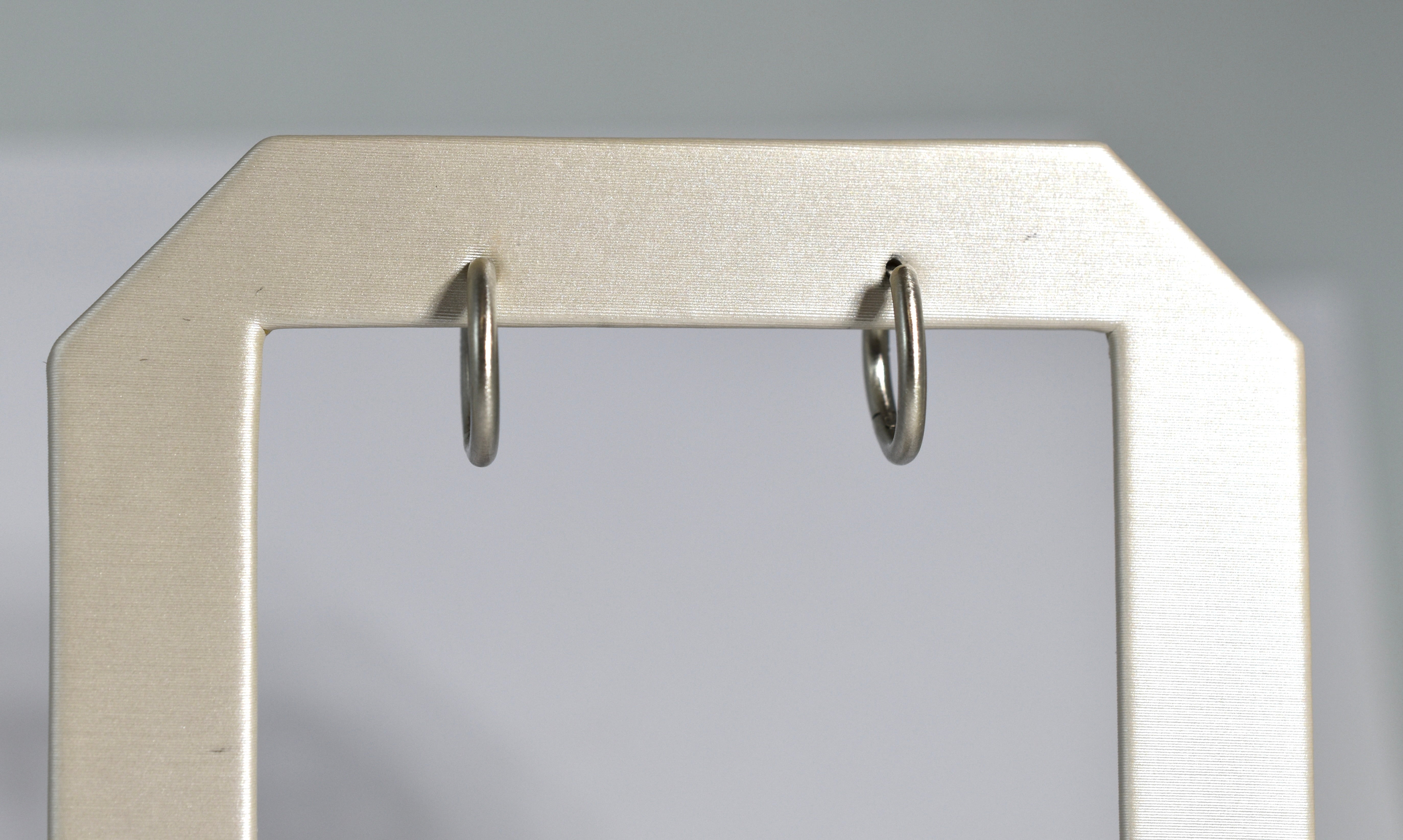 19 karat white brushed gold small locking hoops