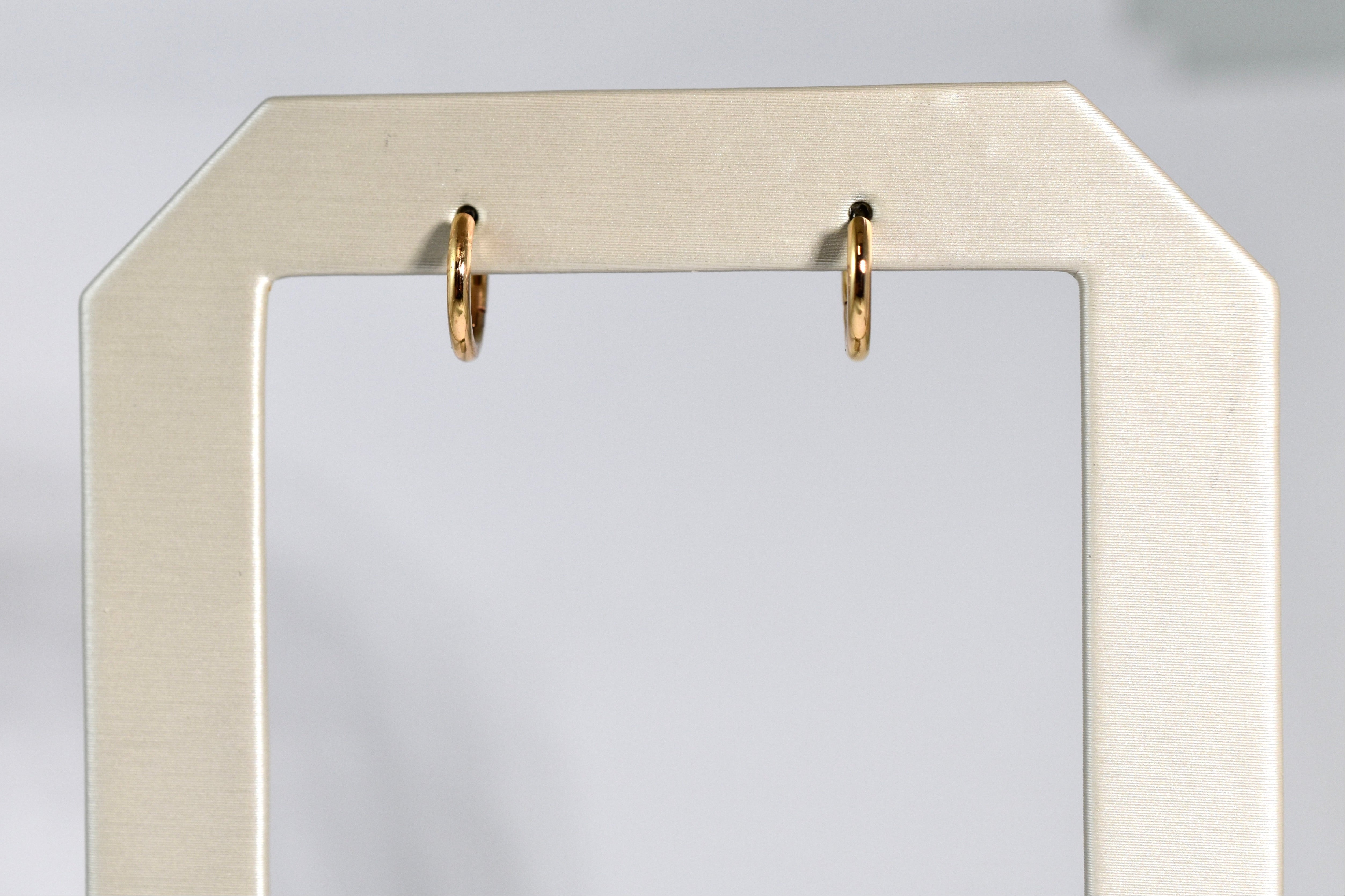 18 karat yellow gold small locking hoops