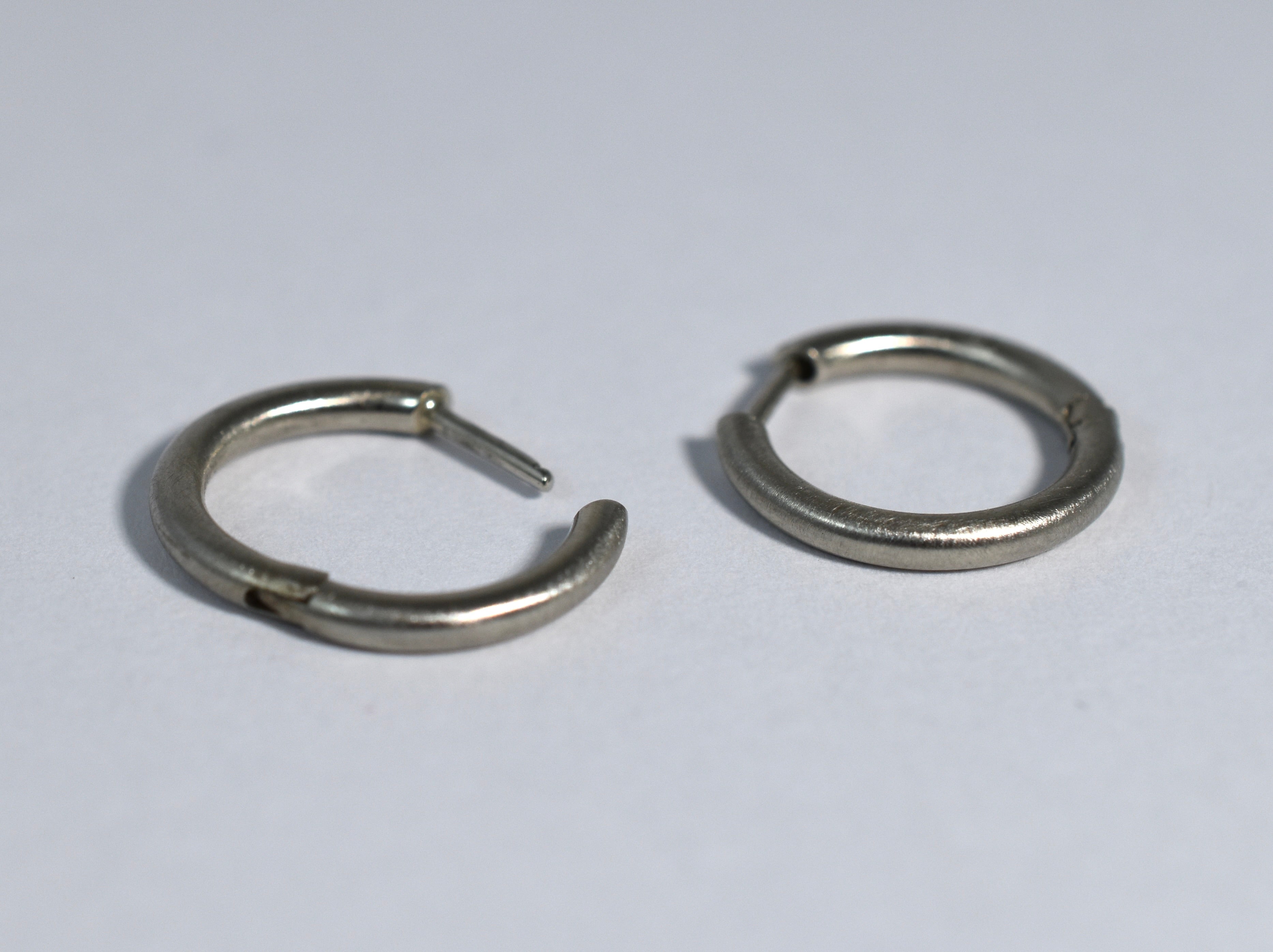 19 karat white brushed gold small locking hoops