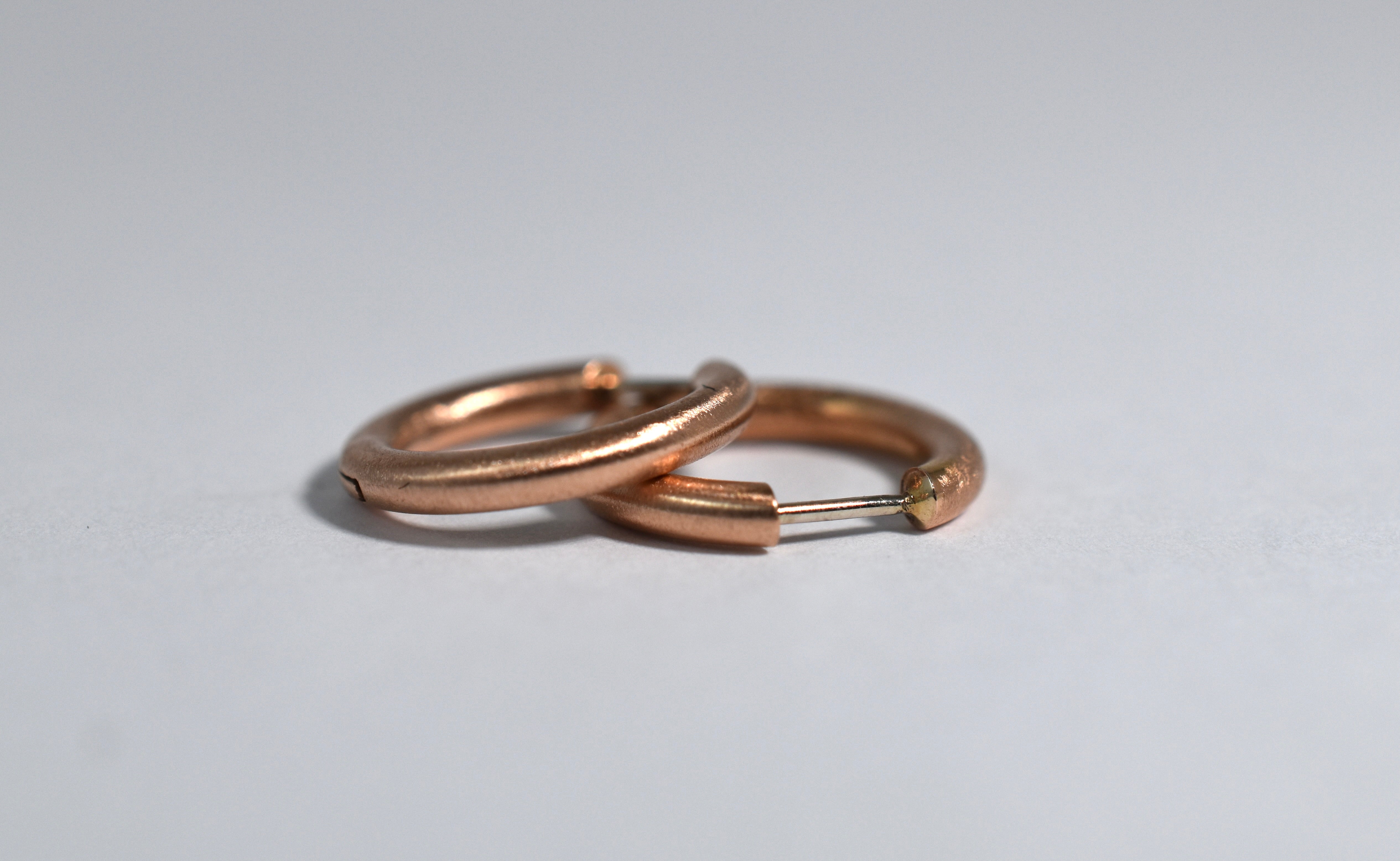 18 karat red brushed gold medium locking hoops