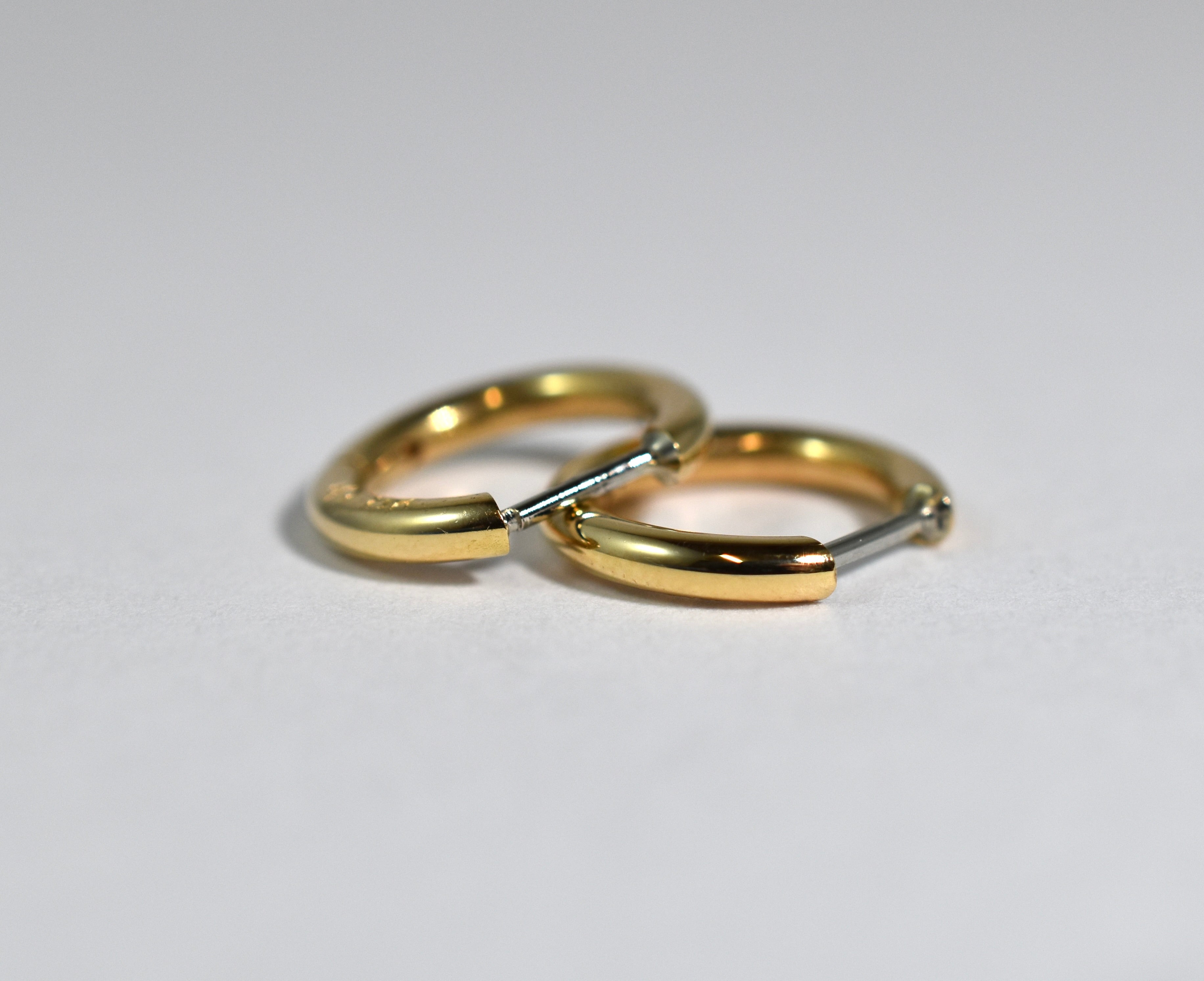 18 karat yellow gold small locking hoops